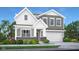 Charming two-story home boasts a two-car garage and a beautifully landscaped front yard with flowering bushes at 8856 Alexander Ridge Dr, McCordsville, IN 46055