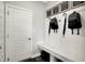 Mudroom with a storage bench, hooks, decor, and access to the front door at 8856 Alexander Ridge Dr, McCordsville, IN 46055