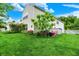 Lush backyard featuring green grass and an array of foliage, set against a clear, blue sky at 9001 Harrison Run Ct, Indianapolis, IN 46256