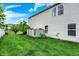 Spacious backyard featuring green grass and a utility shed, set against a clear, blue sky at 9001 Harrison Run Ct, Indianapolis, IN 46256