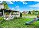 Lush backyard featuring a covered gazebo, a white picket fence, and a slide for outdoor enjoyment at 9001 Harrison Run Ct, Indianapolis, IN 46256