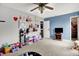 Bright bedroom with a blend of playful decor and functional furniture, featuring carpet and wall art at 9001 Harrison Run Ct, Indianapolis, IN 46256