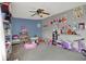 Cozy bedroom featuring colorful decor, playful storage solutions, and comfortable carpet at 9001 Harrison Run Ct, Indianapolis, IN 46256