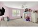 Bright bedroom with pink walls, ceiling fan, and natural light from two windows at 9001 Harrison Run Ct, Indianapolis, IN 46256