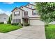 Attractive two-story home with brick and vinyl siding, complemented by a green lawn and driveway at 9001 Harrison Run Ct, Indianapolis, IN 46256