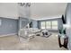 Bright living room with comfortable seating, large windows, and a statement chandelier at 9001 Harrison Run Ct, Indianapolis, IN 46256