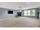 Open living space with a fireplace, large windows, and neutral tones, creating a warm and inviting atmosphere at 9001 Harrison Run Ct, Indianapolis, IN 46256