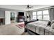 Bright bedroom featuring a fireplace, ceiling fan, and multiple windows at 9001 Harrison Run Ct, Indianapolis, IN 46256