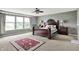 Bright main bedroom featuring a decorative rug, accent wall, and natural light at 9001 Harrison Run Ct, Indianapolis, IN 46256