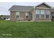 Well-maintained backyard with a patio seating area and a lush green lawn at 9106 Hedley E Way, Avon, IN 46123
