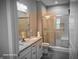 Bright bathroom featuring double vanity, tile flooring, and a glass door shower at 9106 Hedley E Way, Avon, IN 46123