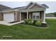 Charming single-story brick home with manicured lawn, covered entry, and attached garage at 9106 Hedley E Way, Avon, IN 46123
