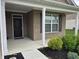 Inviting front porch featuring a modern front door, brick pillars, and manicured landscaping at 9106 Hedley E Way, Avon, IN 46123