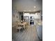 Well-lit kitchen and dining area with stainless steel appliances, and white cabinets at 9106 Hedley E Way, Avon, IN 46123