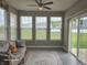 Comfortable sunroom with a ceiling fan, many windows, and a sliding glass door at 9106 Hedley E Way, Avon, IN 46123