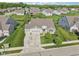 Aerial view of a well-maintained home featuring a three-car garage, lush lawn, and tasteful landscaping at 9656 Summerton Dr, Fishers, IN 46037