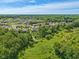 Expansive aerial view of neighborhood nestled amidst mature trees and greenery, including a walking path at 9656 Summerton Dr, Fishers, IN 46037