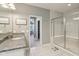 Bright bathroom featuring a glass shower, granite vanity, and an open doorway to an adjacent bedroom and walk-in closet at 9656 Summerton Dr, Fishers, IN 46037