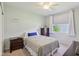 Comfortable bedroom includes a dresser, nightstand, queen bed with patterned duvet, and natural light at 9656 Summerton Dr, Fishers, IN 46037