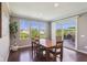 Bright dining room with hardwood floors, a table with chairs, and sliding glass door to the deck at 9656 Summerton Dr, Fishers, IN 46037