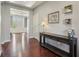 Beautiful foyer with dark hardwood floors, neutral walls, and a charming console table with decor at 9656 Summerton Dr, Fishers, IN 46037