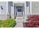 Covered front entry featuring decorative stone supports, a dark-colored door, and glass sidelights at 9656 Summerton Dr, Fishers, IN 46037