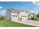 This home boasts an expansive driveway leading to a three-car garage, showcasing ample parking at 9656 Summerton Dr, Fishers, IN 46037