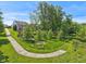 Professionally landscaped yard with mature trees, manicured lawn, and winding pathway at 9656 Summerton Dr, Fishers, IN 46037