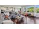 Open living area blending a living room with a glimpse of the kitchen and dining area, plus hardwood floors at 9656 Summerton Dr, Fishers, IN 46037