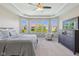 Large primary bedroom with tray ceiling, carpeting, big windows and dresser at 9656 Summerton Dr, Fishers, IN 46037