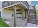 View of the under-deck patio area, featuring an outdoor hot tub and access to stairs at 9656 Summerton Dr, Fishers, IN 46037