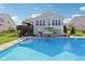 Backyard pool with lounge chairs and an umbrella offering a relaxing outdoor space for summer fun at 9656 Summerton Dr, Fishers, IN 46037