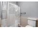 A bathroom with a toilet, shower curtain, gray walls, and beige tile at 970 Fort Wayne Ave # 303, Indianapolis, IN 46202