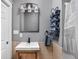 A bathroom vanity with a modern sink, mirror, neutral tile, and stacked blue towels at 970 Fort Wayne Ave # 303, Indianapolis, IN 46202