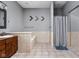 Well-lit bathroom featuring a soaking tub with tile surround and shower with curtain at 970 Fort Wayne Ave # 303, Indianapolis, IN 46202