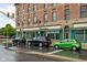 Commercial brick building featuring prominent signage and multiple parked cars and a storefront at 970 Fort Wayne Ave # 303, Indianapolis, IN 46202