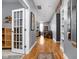 Inviting hallway featuring hardwood floors, built-in shelving, and a glimpse into the living space at 970 Fort Wayne Ave # 303, Indianapolis, IN 46202