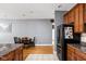 An open concept kitchen with stainless steel refrigerator, light gray walls, and tile floors at 970 Fort Wayne Ave # 303, Indianapolis, IN 46202