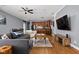 A living room that has a gray sectional sofa, hard wood floors and a view into the kitchen at 970 Fort Wayne Ave # 303, Indianapolis, IN 46202