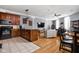 Open-concept living area with a kitchen island, hardwood floors, and ample seating for entertaining guests at 970 Fort Wayne Ave # 303, Indianapolis, IN 46202