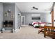 A spacious main bedroom features a modern fireplace, ceiling fan, and neutral carpet at 970 Fort Wayne Ave # 303, Indianapolis, IN 46202