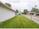 A spacious, well-maintained backyard featuring a lush lawn, garage, and chainlink fence at 1065 36Th St, Indianapolis, IN 46208