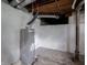 Basement featuring hot water tank and exposed pipes and joists at 1065 36Th St, Indianapolis, IN 46208