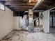 Unfinished basement with exposed ductwork, brick accents, and utilities, ready for customization at 1065 36Th St, Indianapolis, IN 46208