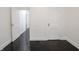Bedroom with dark wood floors, white walls, baseboards, and interior doors at 1065 36Th St, Indianapolis, IN 46208
