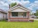 Charming single-story home with a welcoming porch, brick accents and freshly mowed lawn at 1065 36Th St, Indianapolis, IN 46208