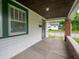 Inviting covered porch with brick accents, concrete flooring, and views of the surrounding neighborhood at 1065 36Th St, Indianapolis, IN 46208