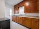 Galley kitchen with wood cabinets, stainless steel appliances, and tile flooring at 1065 36Th St, Indianapolis, IN 46208