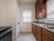 Galley kitchen featuring wood cabinets, stainless steel appliances, and tile flooring at 1065 36Th St, Indianapolis, IN 46208