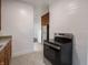 Galley kitchen featuring stainless steel range, refrigerator, tile flooring and ample cabinets at 1065 36Th St, Indianapolis, IN 46208